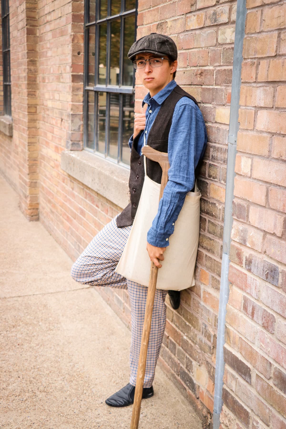 Caleb Morgan as Crutchie in Newsies